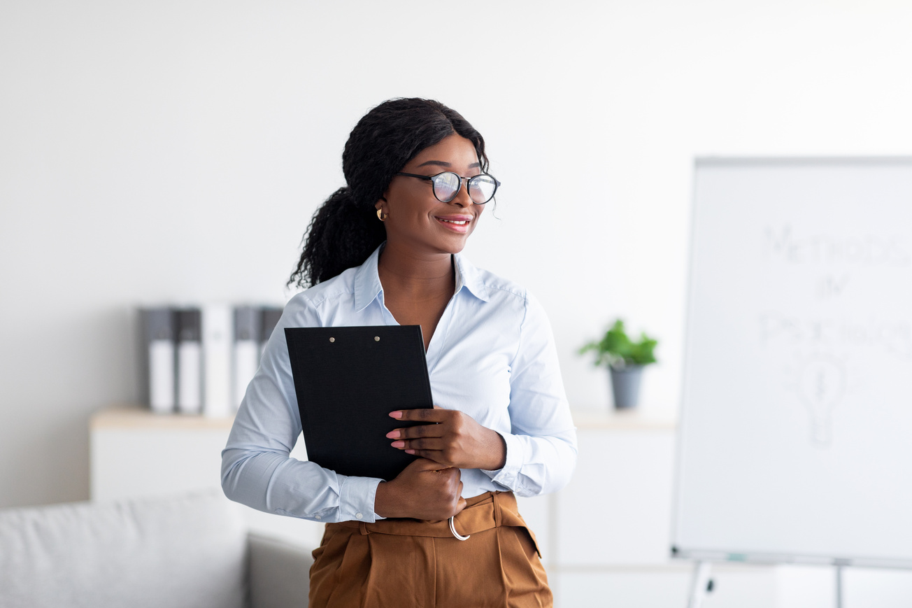 Psychological education concept. Confident black business coach giving professional growth training at office